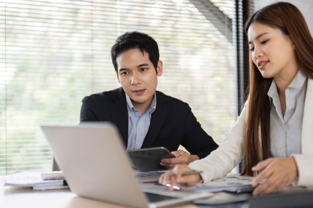 Two professionals in virtual check-in call reviewing goals