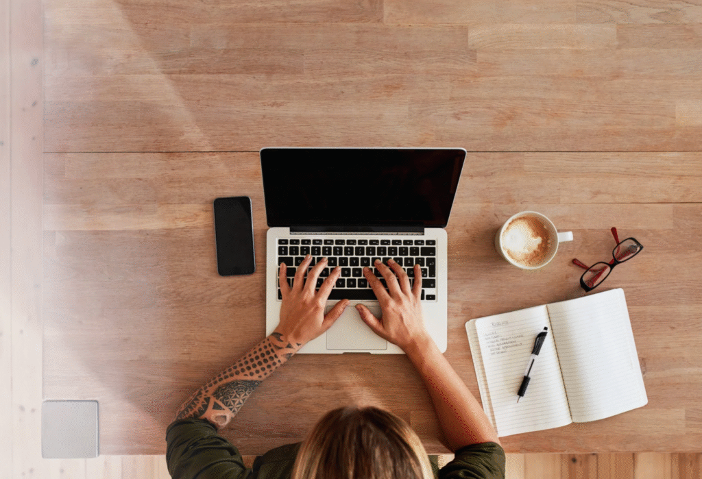 Person typing quickly on a laptop with a timer beside it